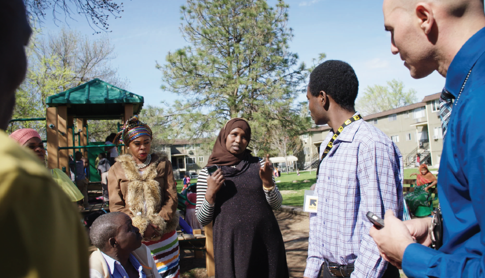 The Boise Police Department often holds information sessions at apartment complexes where many refugees live. Here, Saabo Ambar (center), who is originally from Somalia, discusses child safety laws with Dustin Robinson, Boise’s refugee liaison officer (at far right). Pascal Sabima, of the International Rescue Committee, translates.